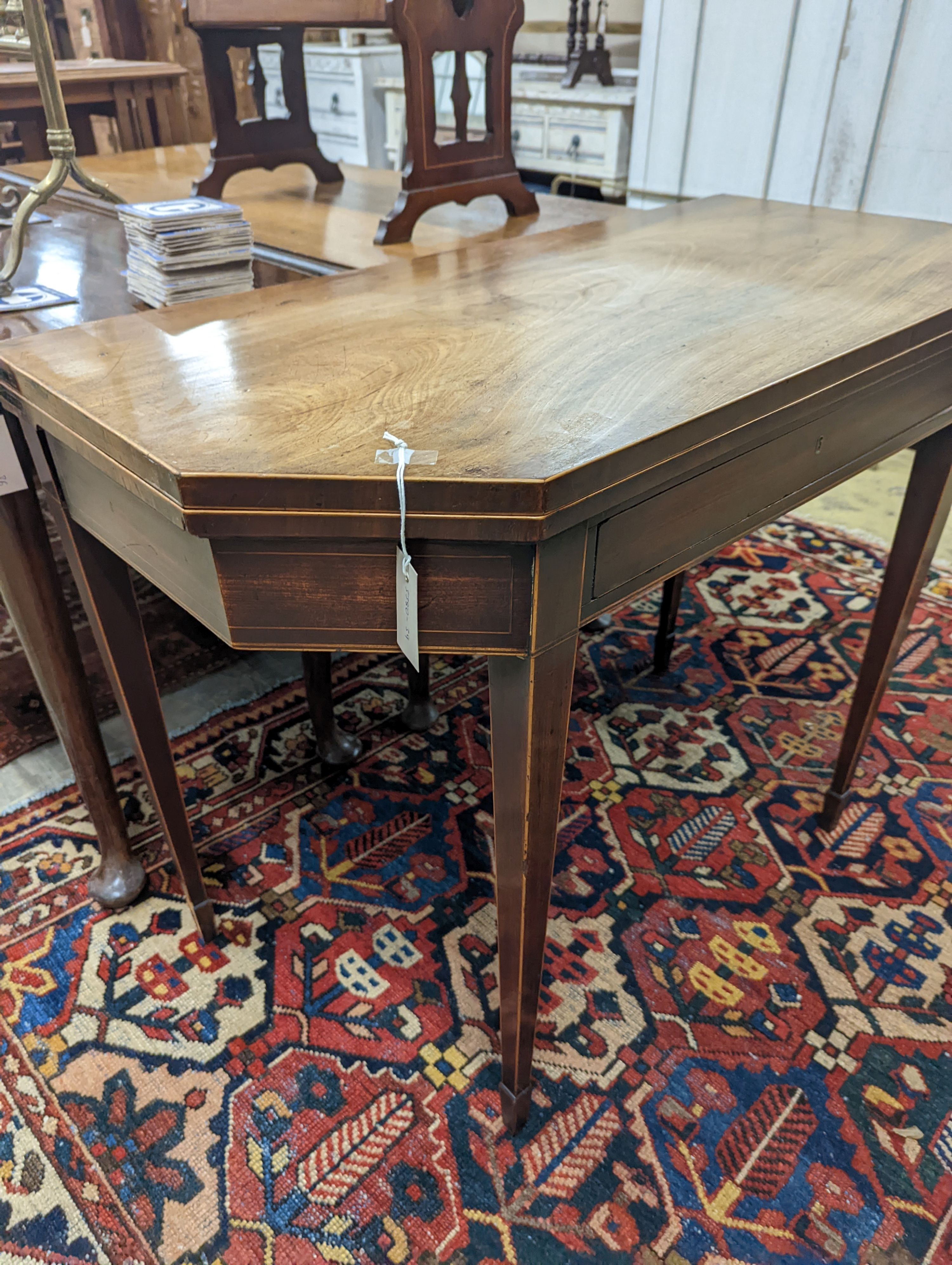 A George III faded mahogany folding tea table, width 97cm, depth 47cm, height 75cm